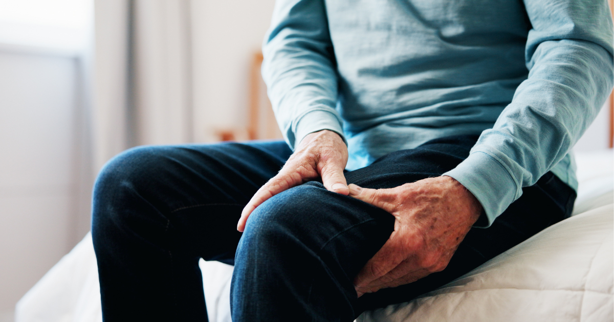 Adult experiencing back and leg pain commonly associated with a herniated disc or pinched nerve.