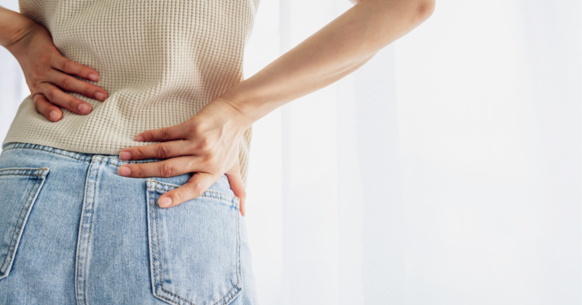 dult experiencing leg numbness while walking, a common symptom of sciatica or spinal stenosis.