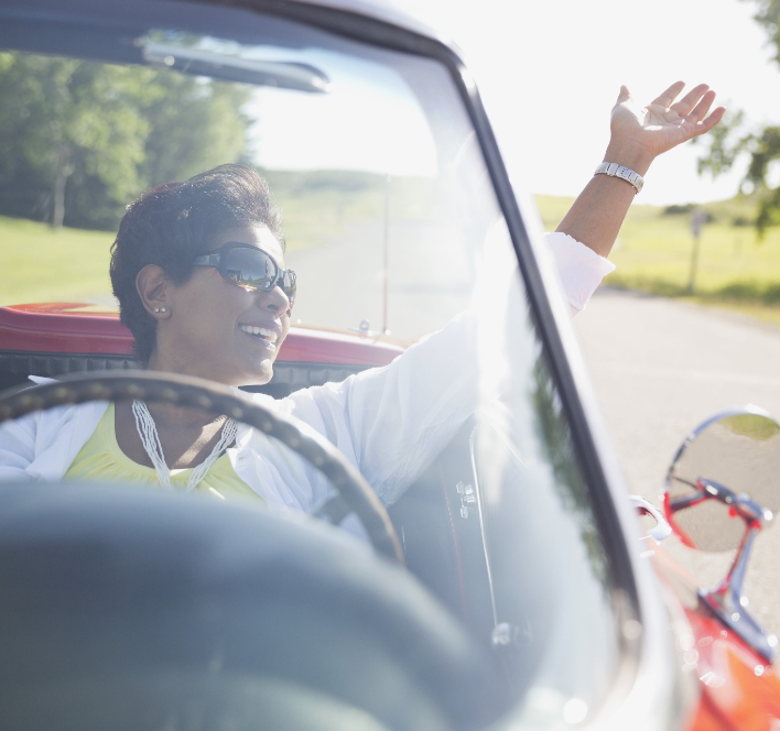 https://www.orthopedicandlaserspinesurgery.com/wp-content/uploads/Woman-driving-a-vehicle-with-one-hand-up-in-the-air-and-smiling.jpg