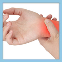 person holding their right wrist in discomfort, indicative of carpal tunnel syndrome pain