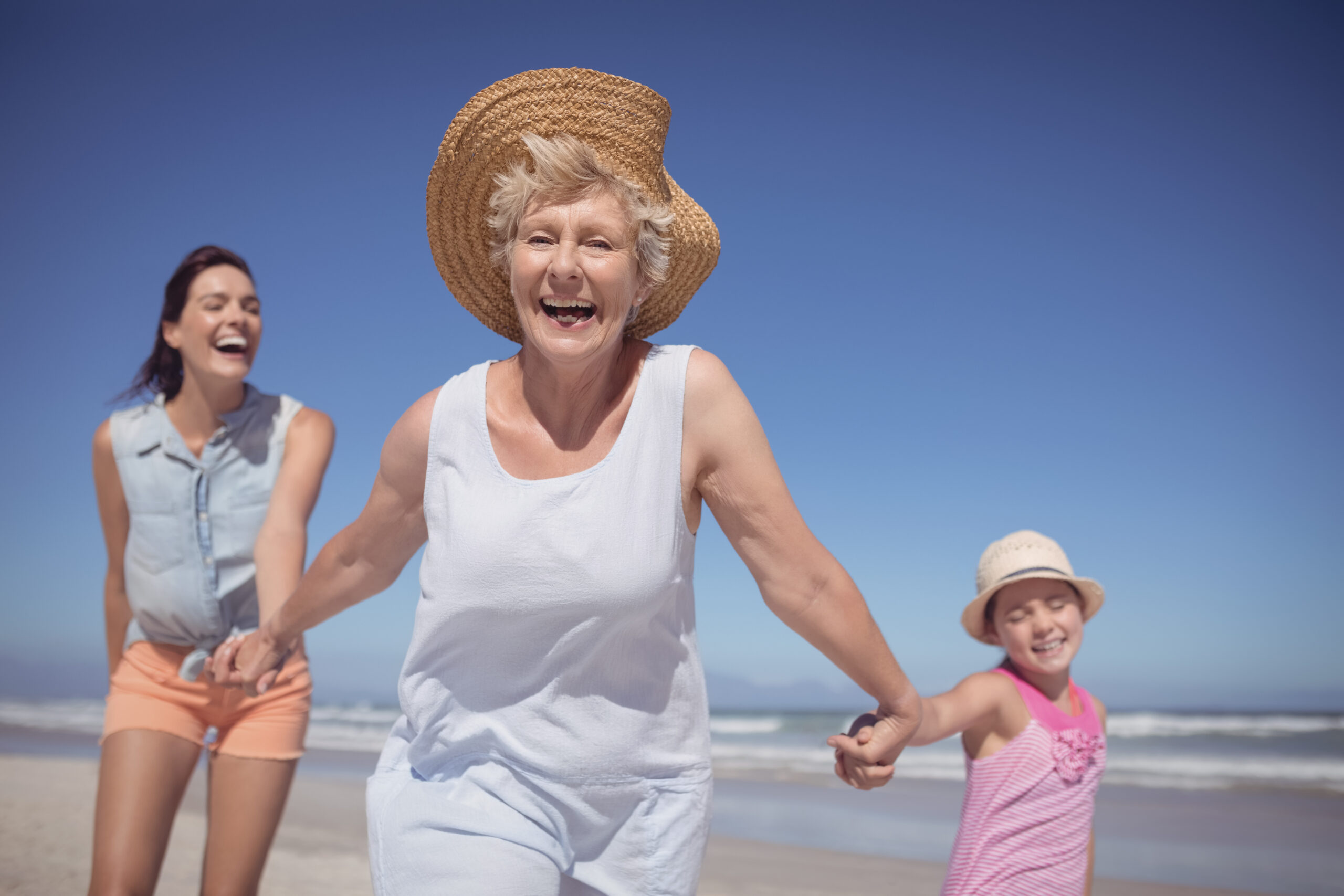 mature-woman-at-beach-with-family-after-minimally-invasive-spine-surgery