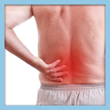 male experiencing lower back pain, highlighting discomfort and spinal health issues