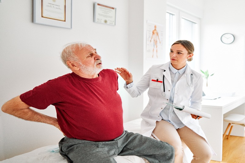 senior-man-seeing-a-doctor-for-his-lower-back-pain